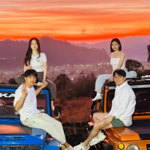 People enjoy the beauty of sunrise from the middle of mount batur.