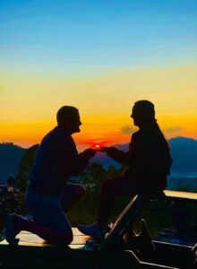 Customer enjoying the breathtaking sunrise view during the Batur Sunrise Jeep Tour, captured at the middle of Mount Batur as the first rays of sunlight illuminate the volcanic terrain.
